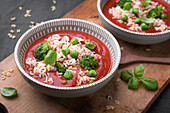 Tomato soup with alphabet noodles and green vegetables