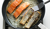 Frying salmon fillets with skin in a pan