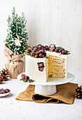 Layered Christmas cake with cranberries, sliced