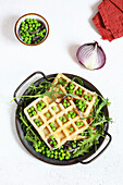 Sage waffles with peas and rocket salad