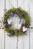 Wreath made of moss and sloes (Prunus spinosa)