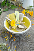 Tea bowl with napkin, name tag and marigolds
