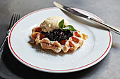 Waffle with blackcurrant jam and vanilla ice-cream