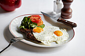 Fillet steak with fried eggs, hashbrown and grilled tomato