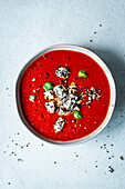 Simple tomato-paprika soup with sesame feta