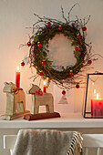 Christmas wreath and wooden animals as candle holders