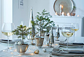 Festive table setting with fir greenery and wine glasses at Christmas time