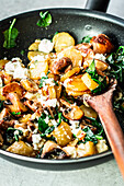 Simple potato and mushroom with feta and spinach cooked in a pan