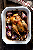 Fried chicken with red onions, garlic, and herbs