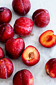 Red plums, whole and halved