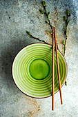Spring table setting with first leaves and flowers of cherry tree served on the modern concrete table