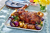 Roasted lamb shoulder with potatoes and red onions