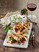 French bread pizza with minced meat and mushrooms