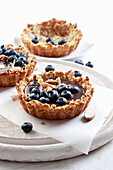 Chocolate mousse and blueberries tartlet with an oat crust