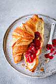Croissant with jam on a light background