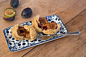 Plum dumplings made of curd and semolina dough with breadcrumbs