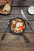Mushroom and cannellini beans dish with a poached egg