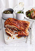 Smoked salt-crusted pork with lentils and caper sauce