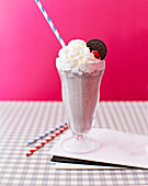 Milkshake 'Dalmation' with cream against a red background