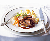 Roast duck with spiced clementine sauce, glazed baby vegetable and truffled crushed potatoes