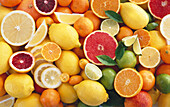 Various citrus fruits, whole and halved (full picture)