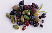 Green and black olives on a light background