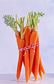 Peeled carrots tied together with a ribbon