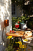 A strawberry drink on a vintage chair in a summery backyard