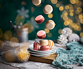 Falling macarons with twinkling lights in the background