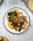 Vegan kale salad with quinoa, mushrooms and orange slices