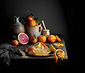 Still life with citrus fruits and and a citrus press