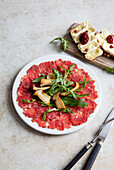 Carpaccio with herbs, mushrooms, and Camembert cranberry bread