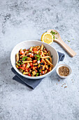 Oriental pasta salad with tomatoes and aubergines