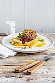 Filet mignon with walnut crust served with salsify and orange fillets