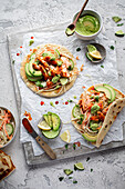 Naan bread with grilled salmon, avocado and lime