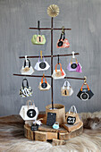DIY advent calendar made of mini origami handbags on a fir tree made of twigs