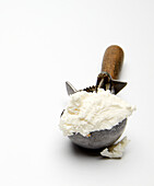 Scoop of vanilla ice cream in a vintage ice cream scoop