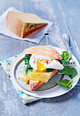 Sandwich with cheese, spinach, and poached egg