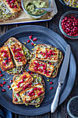 Wholemeal bread with guacamole, sprouts, halloumi and pomegranate seeds