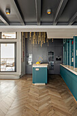 Kitchen with blue cabinet fronts in a loft flat