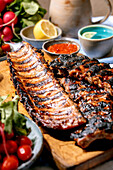 Grilled BBQ pork ribs with sauce and vegetables