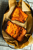 Organic pumpkin slices roasted in oven with honey and walnuts