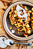 Vegan pumpkin waffles with baked apple and roasted almonds