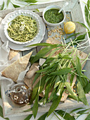 Spaghetti with wild garlic pesto surrounded by ingredients