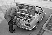 Man checking an electric car, 1974