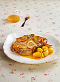 Horse osso buco with orange sauce and potatoes