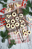 Jam biscuits on a Vintage cooling rack, holly berries, twigs, and cinnamon stick