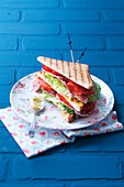 Club sandwich with bacon, lettuce, and tomatoes