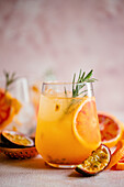 Blood orange cocktail with prosecco and passion fruit