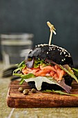 Black burger with fresh salmon